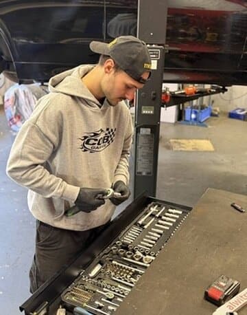 Crew-Mitglied im COB-Hoodie am Werkzeugwagen